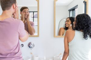 woman and man looking at mirror