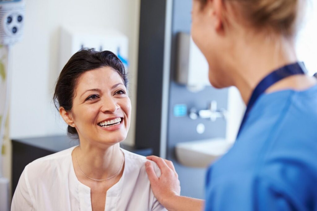 Smiling patient speaking with a dental professiona