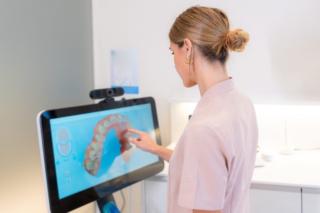 Dentist reviewing digital dental scan on screen in clinic