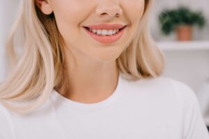 Smiling woman showing healthy white teeth in a close-up portrait.
