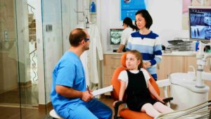 Family with a child attending a dental appointment.